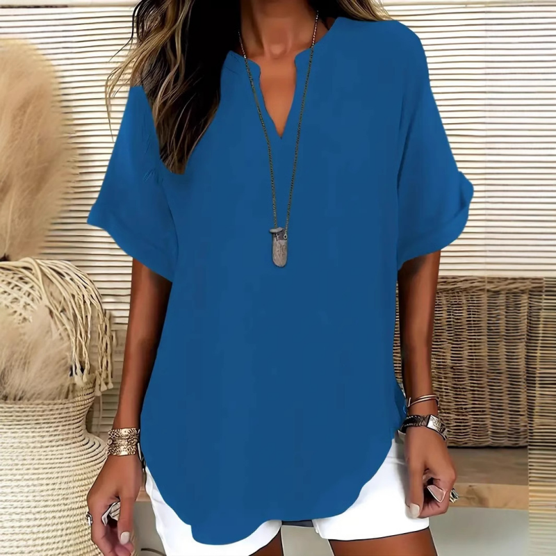 Blusa elegante y holgada con cuello abierto