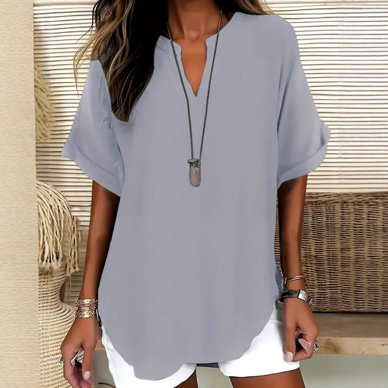 Blusa elegante y holgada con cuello abierto